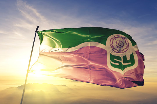 South Yorkshire county of England flag waving on the top sunrise mist fog