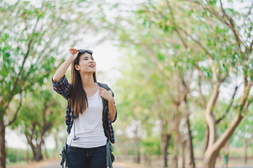 Portrait of a young attractive happy Asian woman traveler backpacker background with copy space