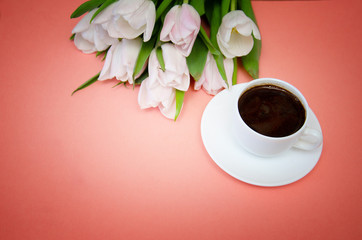 white tulips with white coffee Cup on pink background