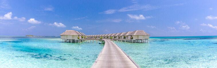 Landscape of Maldives beach. Tropical panorama, luxury water villa resort with wooden pier or jetty. Luxury travel destination background for summer holiday and vacation concept
