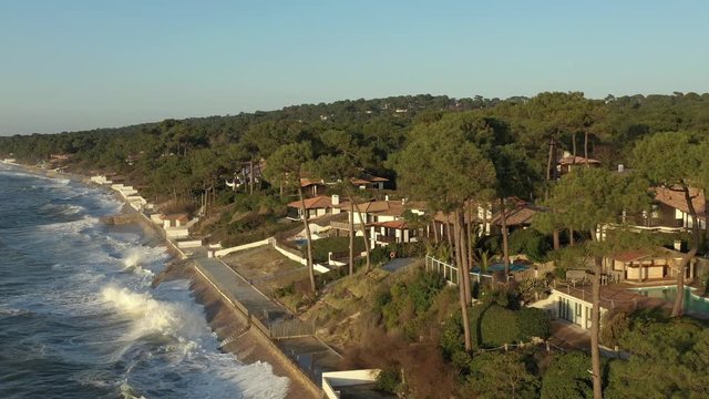 Drone flies over the shoreline of the resort Le Pilat Plage. The great waves of the Atlantic strike against the coast