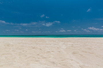 Fototapeta na wymiar Empty beach scene with white sand and blue sea view. Sea sand sky concept