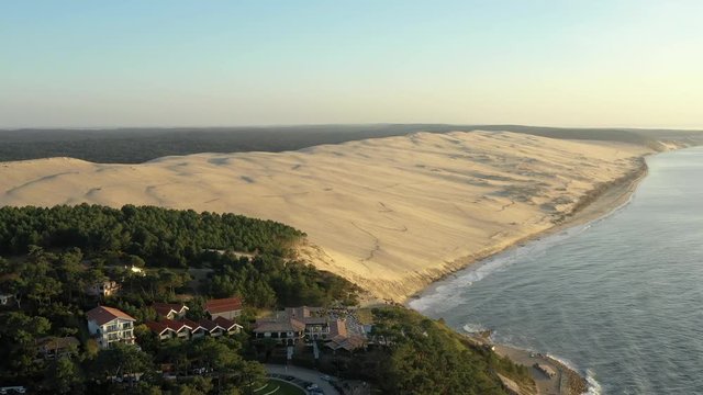 Drone flies over the largest sand dune in Europe. Aerial of the enormous Dune du Pilat extends beyond Le Pilat Plage