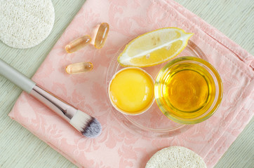 Olive oil, raw egg, lemon and vitamin E softgels - ingredients for preparing diy face and hair masks, scrubs and moisturizers. Homemade beauty treatments recipe. Top view, copy space
