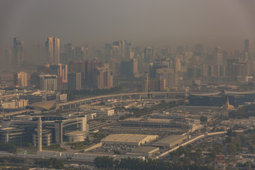 Naklejka na ściany i meble Dubai shrouded in a sandstorm as seen from the air 