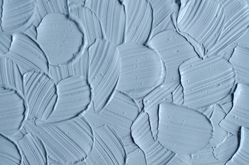 Gray cosmetic clay (facial mask, cream, body scrub) texture close up. Abstract background with brush strokes.