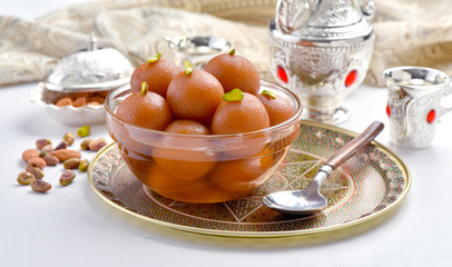 Gulab Jamun or Gulab Jaman in crystal bowl with arabian crockery