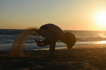 Child playing in sand on the beach. Cheerful boy play on send on summer holiday