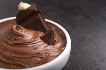 Sweet chocolate cream with bars and nuts