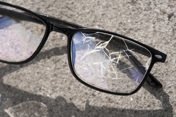 broken glasses lying on the street asphalt