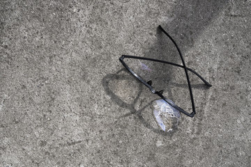broken glasses lying on the street asphalt