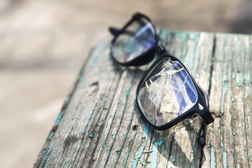 Black broken glasses lie