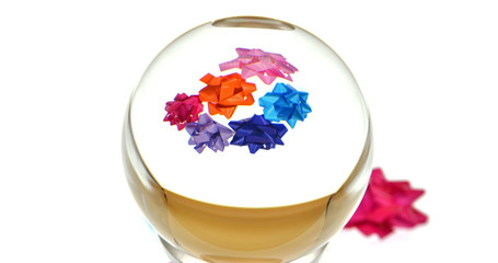 gift package ribbon with lens ball on white background