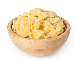 Bow tie pasta in wooden bowl isolated on white background with clipping path