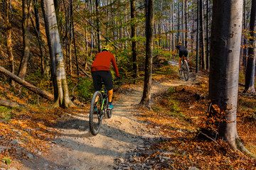 Cycling man riding on bike at sunset mountains forest landscape. Cycling MTB enduro flow trail track. Outdoor sport activity.