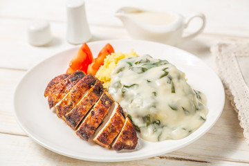 Chicken breast, mashed potatoes with spinach in cream sauce. Dietary food