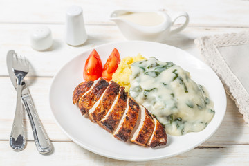 Chicken breast, mashed potatoes with spinach in cream sauce. Dietary food