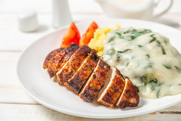 Chicken breast, mashed potatoes with spinach in cream sauce. Dietary food