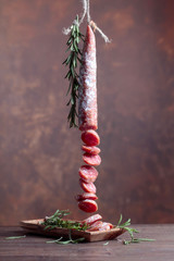 Dry-cured sausage with rosemary.
