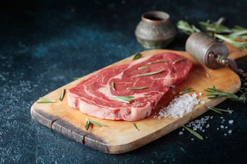 Fresh raw beef steak on wooden board.
