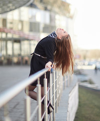 successful business woman standing near a modern office building