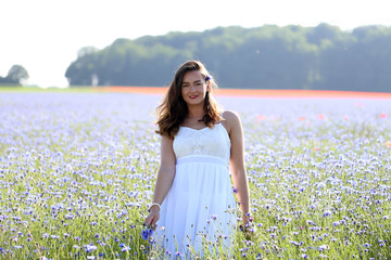 Portrait of a young girl on cornflower blue field