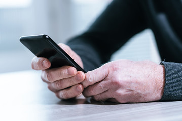 Male hands using a smartphone