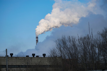 the pipes of the plant emit smoke and gas into the atmosphere.