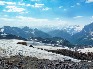 Snowy mountain landscape of Elbrus on a Sunny summer day. Glaciers and rocks.