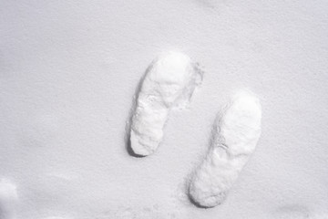 The picture of footprints or foot step on the snow.