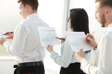 close up. employees with financial reports standing in line