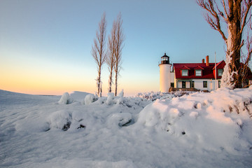 Winter Lighthouse On The Great Lakes. Beautiful winter landscape on the  coast of Lake Michigan...