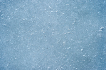Ice with air bubbles of a blue shade. Textured abstract natural background