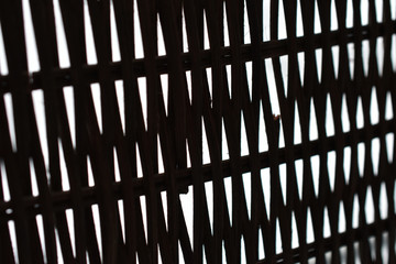 lattice of intertwined black rods on a white background in perspective
