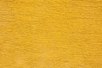 Eine gelbe Fassade Mauer mit Struktur als Hintergrund