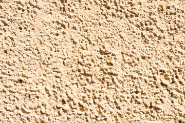 Eine beige Fassade Mauer mit Struktur als Hintergrund