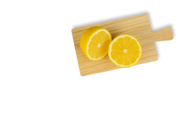 Fresh yellow lemons on wooden cutting board isolated on white background - image