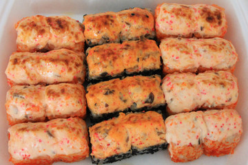 Sushi roll set top view on plate. Baked salmon and eel unagi rolls tasty famous japanese food for lunch or dinner. Asian cuisine menu seafood options, tasty freshly cooked hot sushi close up view