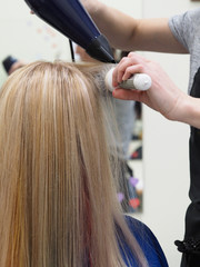 Naklejka premium Hair dryer drying after coloring. Beauty concept.