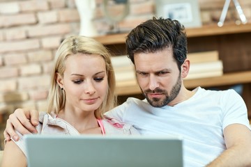 Closeup photo of couple using laptop