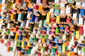 Fototapeta na wymiar a lot of colored pencils blurred background