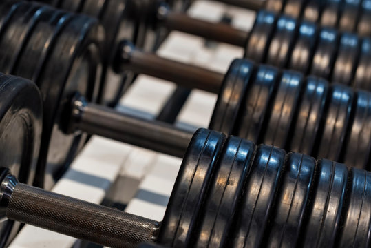 Close up image of chrome dumbbells in gym