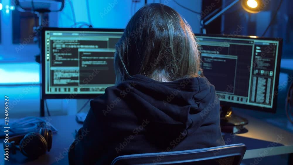 Poster cybercrime, hacking and technology concept - female hacker in dark room creating code or using compu