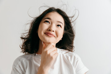 Remember all. Let me think. Doubt concept. Doubtful, thoughtful woman remembering something. Young asian emotional woman. Human emotions, facial expression concept. Studio.