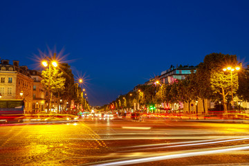 Fototapeta na wymiar tourists at night in the most famous avenue in Paris of France, the Champs Elysees, known for luxury and shopping that starts from Place de La Concorde to Place Charles de Gaulle.