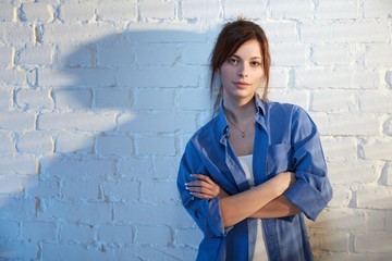 Young woman standing arms crossed