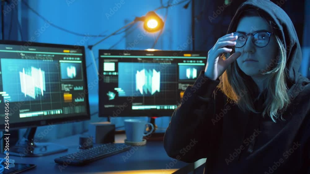 Poster cybercrime, hacking and technology concept - female hacker in dark room creating code or using compu