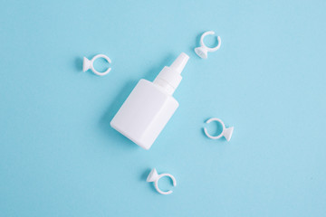 tube of glue for eyelash extensions on a turquoise background