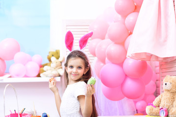 Fototapeta na wymiar Cute little child wearing bunny ears on Easter day.