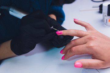 Close up of process france manicure at beauty salon.